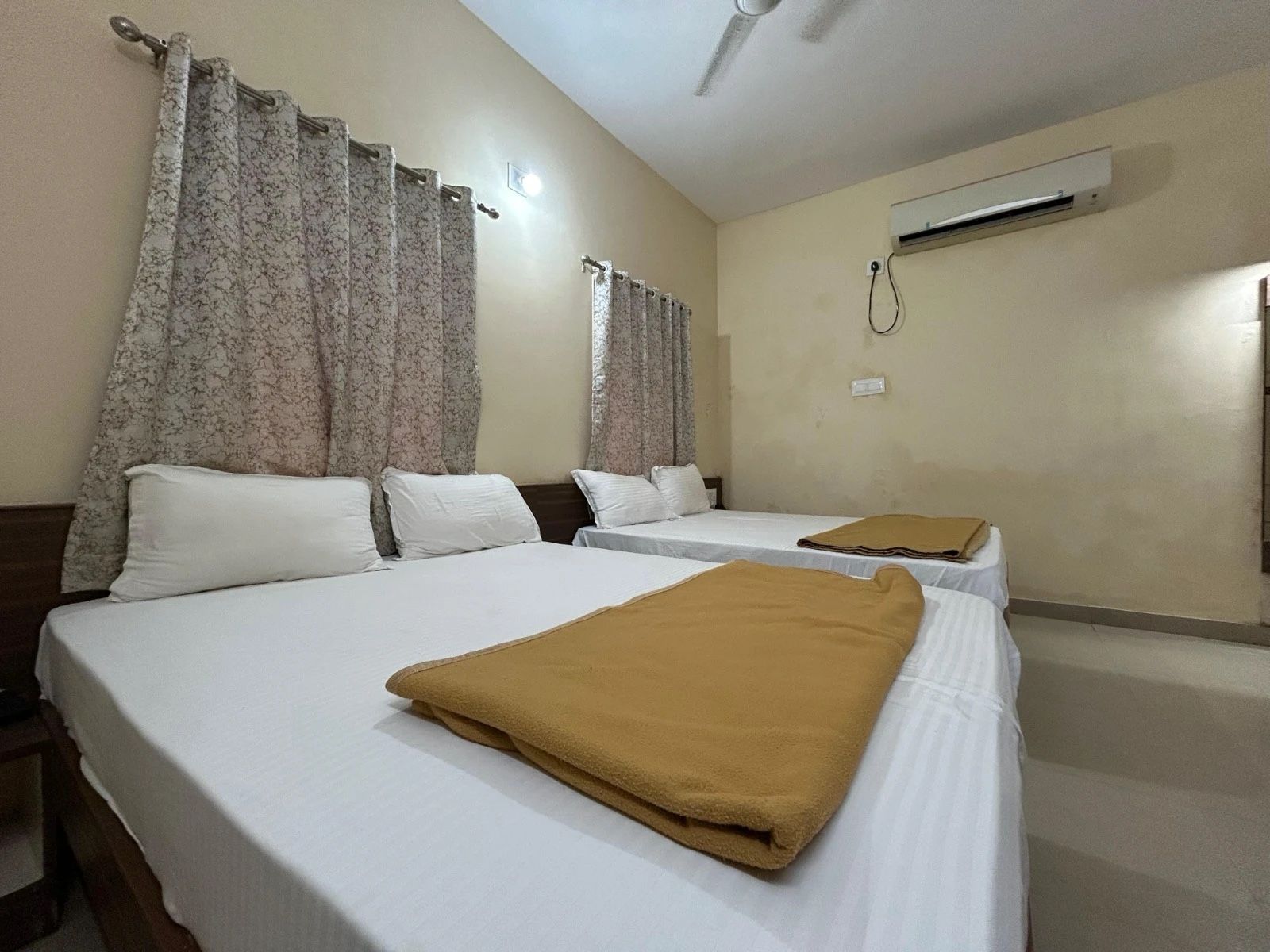 4-Bed AC room with two double beds, white linen and a split AC
